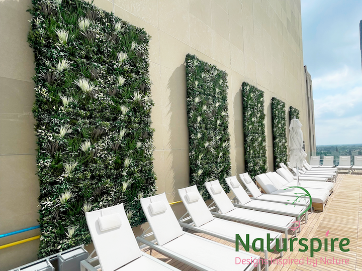 Artificial Green Wall hung outside on the pool deck of 220 North Apartment