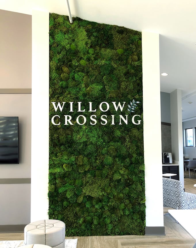 Moss wall with logo displayed in Willow Crossing lobby